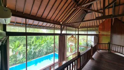 a room with a view of a pool in a house at 2 Minutes Walk to the Beach 3BR Retreat Villa in Canggu