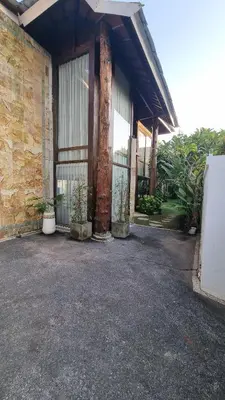a building with two large trees in front of it at 2 Minutes Walk to the Beach 3BR Retreat Villa in Canggu