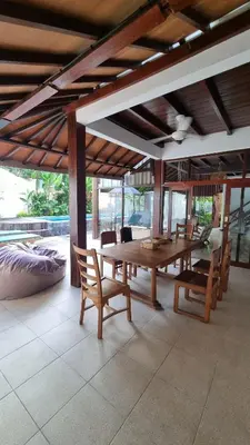 a dining room with a wooden table and chairs at 2 Minutes Walk to the Beach 3BR Retreat Villa in Canggu
