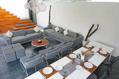 a living room with a couch and a table and chairs at Modern & Central 3 Bedroom plus cinema in Seminyak
