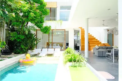 a house with a swimming pool with a house at Modern & Central 3 Bedroom plus cinema in Seminyak