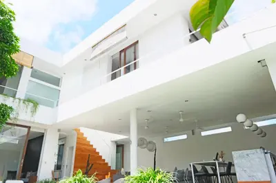 a modern house with white walls and windows at Modern & Central 3 Bedroom plus cinema in Seminyak