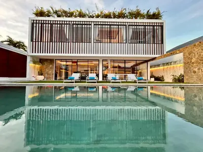 a house with a pool in front of it at Villa Kawis Seminyak in Seminyak