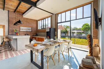 a kitchen and dining room with a table and chairs at Villa N'Zo By DreamAwayBali in Seminyak