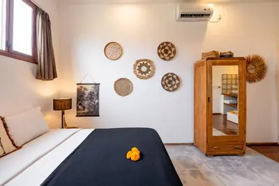 a bedroom with a bed and a mirror at Villa N'Zo By DreamAwayBali in Seminyak