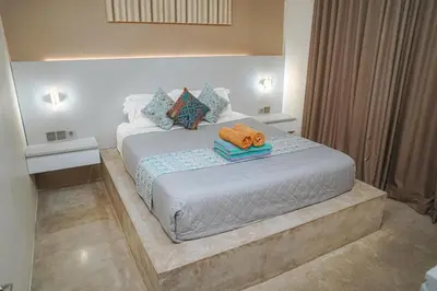 a bedroom with a bed with two towels on it at 5 bedroom villa in kuta with 2 swimingpool in Kuta