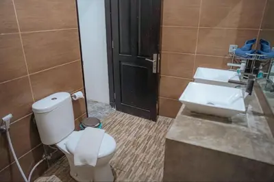a bathroom with a toilet and a sink at 5 bedroom villa in kuta with 2 swimingpool in Kuta