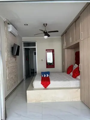 a bedroom with a large bed with red pillows on it at 5 bedroom villa in kuta with 2 swimingpool in Kuta