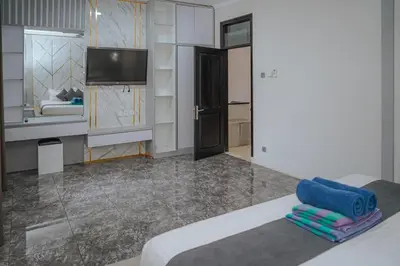 a room with a bed and a tv and a room at 5 bedroom villa in kuta with 2 swimingpool in Kuta