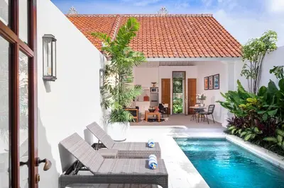 a villa with a swimming pool and a house at Ti - 1BR pool villa in the heart of Seminyak in Seminyak