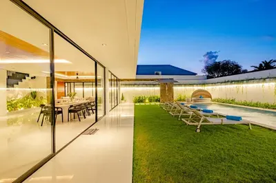 an external view of a house with a garden at Villa Kamawis Seminyak in Seminyak
