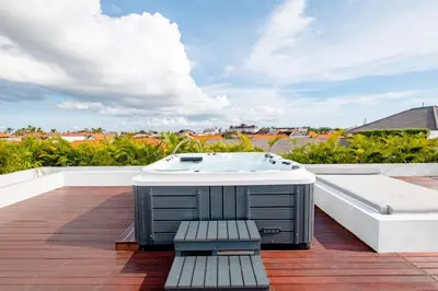 a hot tub on the roof of a house at Villa Kamawis Seminyak in Seminyak