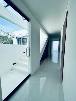 an empty hallway with a glass door and stairs at Villa Kamawis Seminyak in Seminyak