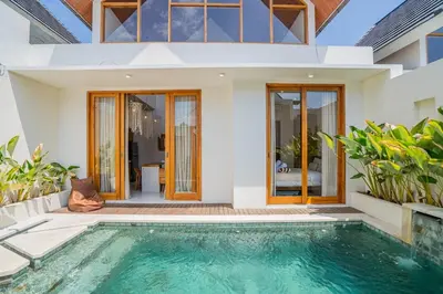 a villa with a swimming pool and a house at Sunrise Oasis - 2BR Villa in Kerobokan in Kerobokan