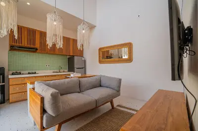 a living room with a couch and a table at Sunrise Oasis - 2BR Villa in Kerobokan in Kerobokan