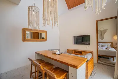 a dining room with a table and a mirror at Sunrise Oasis - 2BR Villa in Kerobokan in Kerobokan