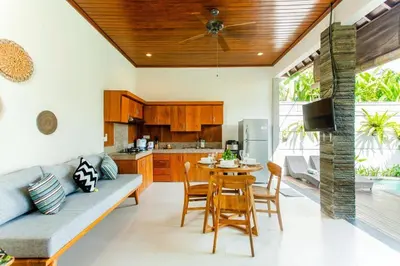 a kitchen and dining room with a table and chairs at Dion Villas Berawa only 5 Minutes by scooter to Finns beach club in Canggu