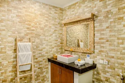 a bathroom with a sink and a mirror at Dion Villas Berawa only 5 Minutes by scooter to Finns beach club in Canggu