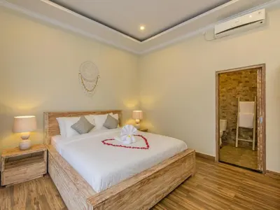 a bedroom with a large white bed in a room at Dion Villas Berawa only 5 Minutes by scooter to Finns beach club in Canggu