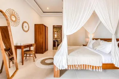 a bedroom with a bed with a mosquito net at Dion Villas Berawa only 5 Minutes by scooter to Finns beach club in Canggu
