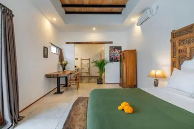 a bedroom with a bed with a teddy bear on it at Villa Wuizy By DreamAwayBali in Seminyak
