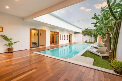 a swimming pool in the middle of a house at Villa Wuizy By DreamAwayBali in Seminyak