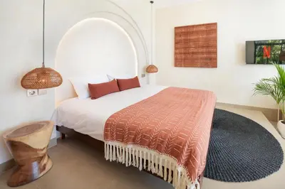 a bedroom with a bed with an arched window at Villa Benteke Umalas in Kerobokan