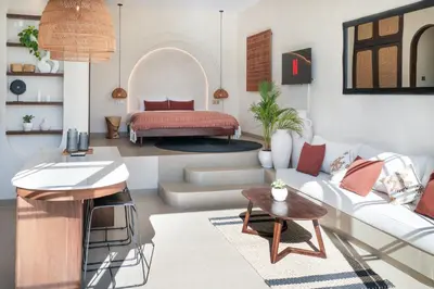 a living room with a white couch and a bed at Villa Benteke Umalas in Kerobokan