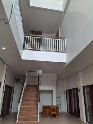 a staircase in a building with a wooden table at Ayoolasudi in Kerobokan