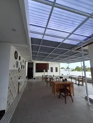 a large room with tables and benches in a building at Ayoolasudi in Kerobokan