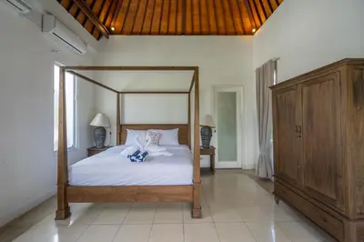 a bedroom with a canopy bed in a room at 2BR Villa walking distance to Finns & Atlas in Canggu
