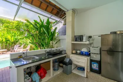 a kitchen with a sink and a refrigerator at 2BR Villa walking distance to Finns & Atlas in Canggu