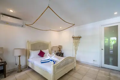 a bedroom with a bed with two towels on it at 2BR Villa walking distance to Finns & Atlas in Canggu