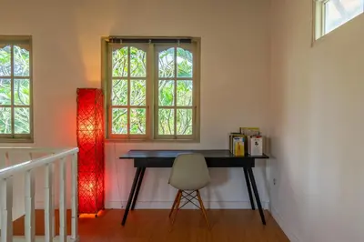 a table in a room with a chair and two windows at 2BR Villa in Umalas next to Seminyak & Canggu in Kerobokan