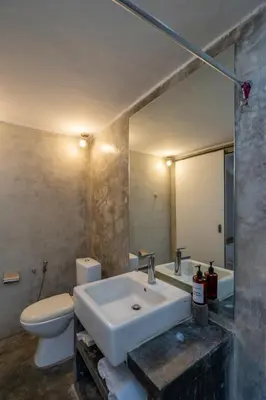 a bathroom with a sink and a toilet and a mirror at 2BR Villa in Umalas next to Seminyak & Canggu in Kerobokan