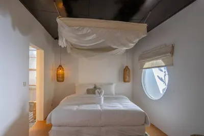 a bedroom with a white bed and a window at 2BR Villa in Umalas next to Seminyak & Canggu in Kerobokan