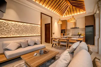 a living room with a couch and a table at Villa Advaya by Maheswara in Seminyak