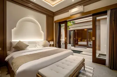 a bedroom with a large bed and a balcony at Villa Advaya by Maheswara in Seminyak