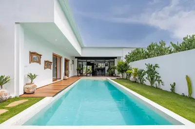 a swimming pool in the backyard of a house at Villa Wampu By DreamAwayBali in Seminyak
