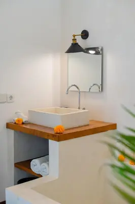 a bathroom with a sink and a mirror at Villa Wampu By DreamAwayBali in Seminyak