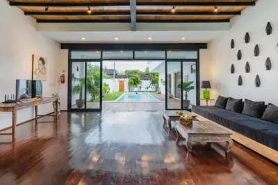 a living room with a couch and a table at Villa Wampu By DreamAwayBali in Seminyak