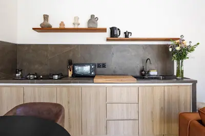 a kitchen with a counter with a sink and a microwave at Pool Garden Private 2BR Villa - 10 min to Finns Beach Club in Canggu