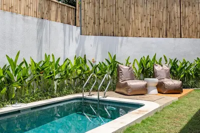 a swimming pool in a backyard with a fence at Pool Garden Private 2BR Villa - 10 min to Finns Beach Club in Canggu