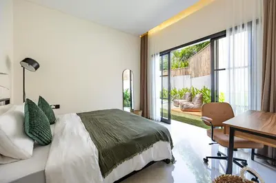 a bedroom with a bed and a table and a desk at Pool Garden Private 2BR Villa - 10 min to Finns Beach Club in Canggu