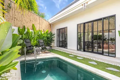 a swimming pool in the backyard of a house at Pool Garden Private 2BR Villa - 10 min to Finns Beach Club in Canggu