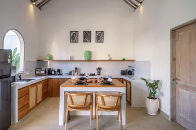 a kitchen with a table and two chairs in it at La Palma - Spacious 2BR Villa with Large Pool in Canggu in Canggu