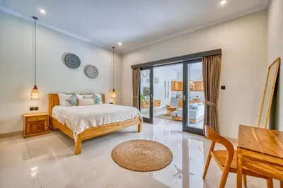 a bedroom with a bed and a dining room at Villa D Canggu in Canggu