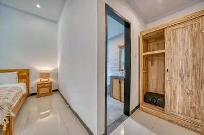 a bedroom with a bed and a sliding glass door at Villa D Canggu in Canggu