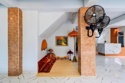 a hallway with a staircase in a room at Townhouse Oak Legian Near Kuta Beach Formerly Sayang Maha Merta in Legian