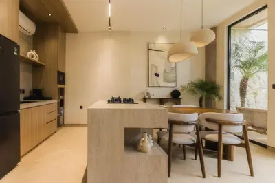 a kitchen and dining room with a table and chairs at CAVO Villa in Seminyak